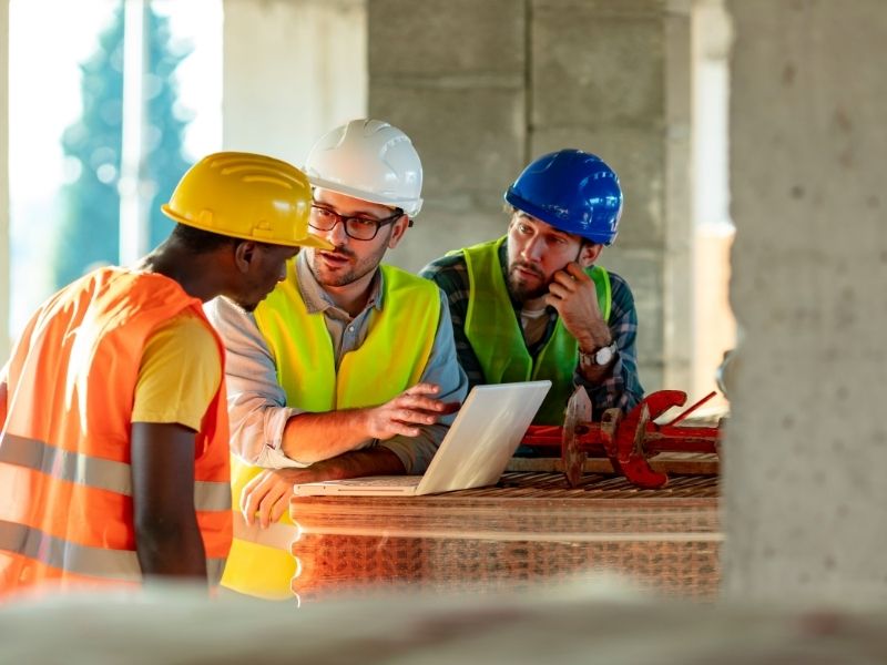 Construction managers reviewing project progress