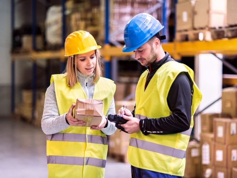 Warehouse employees handling inventory and packaging